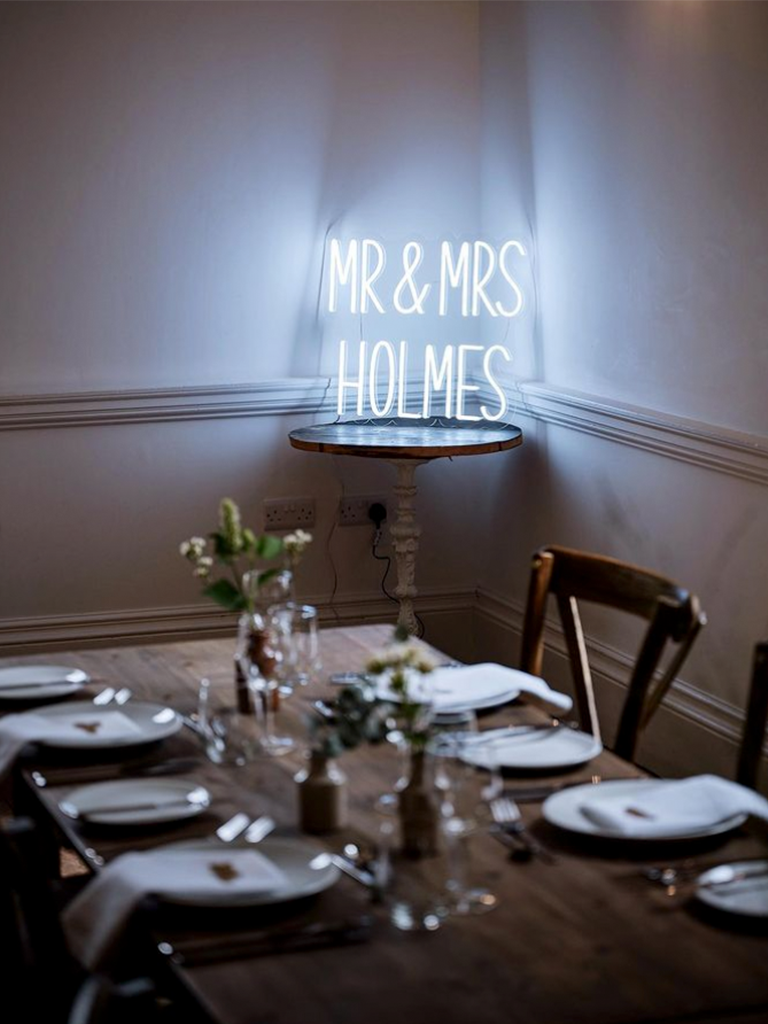 Photo of Mr & Mrs Holmes LED neon sign displayed by a table