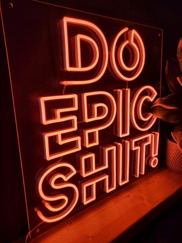 Photo of peach pink LED neon sign saying Do epic shit! by Love Inc.